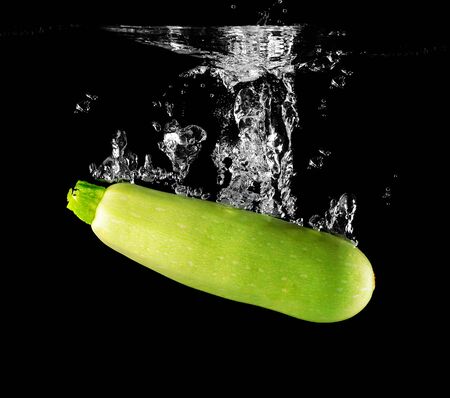 Zucchini falling in water. design elementの写真素材