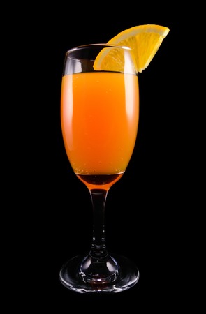 Mimosa cocktail with a slice of orange on a black background closeupの写真素材