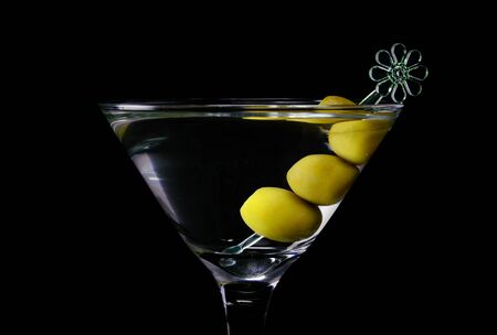 Martini cocktail with olives on a black background closeupの写真素材