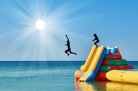 Silhouette of people jumping from the water slide. recreation concept on the waterの写真素材