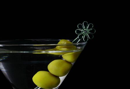 Martini cocktail with olives on a black background closeupの写真素材