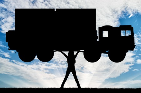 Silhouette of strong feminist, lifting trucks. Concept of feminism.の写真素材