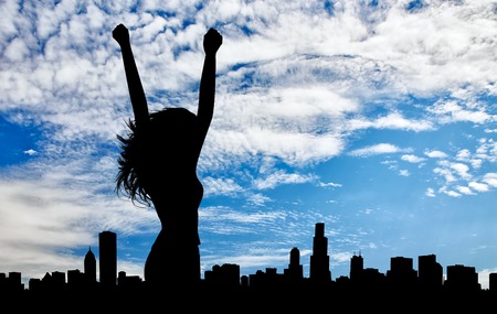 Silhouette of the happy woman on a background of cityscape dayの写真素材