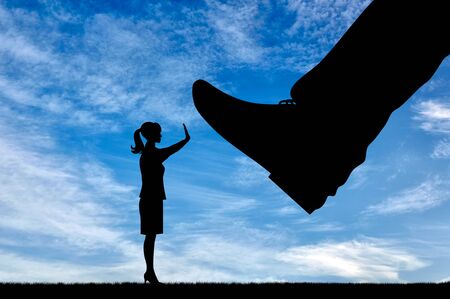 Discrimination and racism concept. Silhouette legs wants to crush the woman who stops herの写真素材