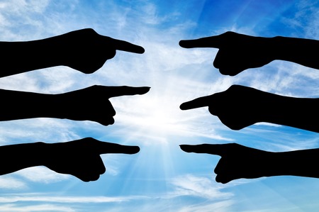 Concept of the conflict parties. Silhouette of hands of people point the finger at each otherの写真素材