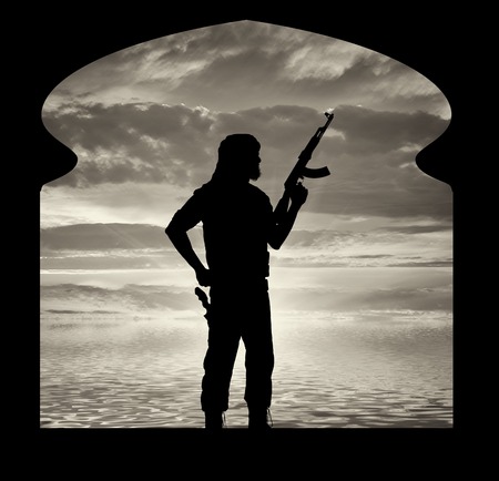 Terrorism and conflict. Armed terrorists in the premises of the mosque on sunset backgroundの写真素材