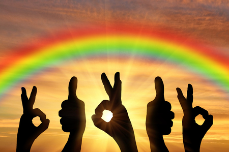 Gesture ok. Hand Gesture ok and good, against the backdrop of a rainbow sunsetの写真素材