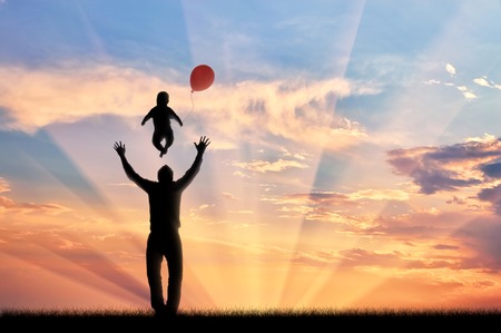 Happy dad playing with child and balloon sunset. concept of family and happinessの写真素材