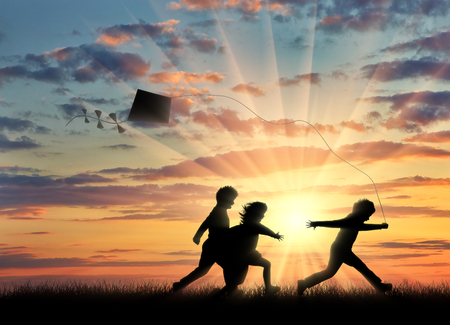 ?hildren playing in the street with a kite . ?oncept childhood and friendshipの写真素材