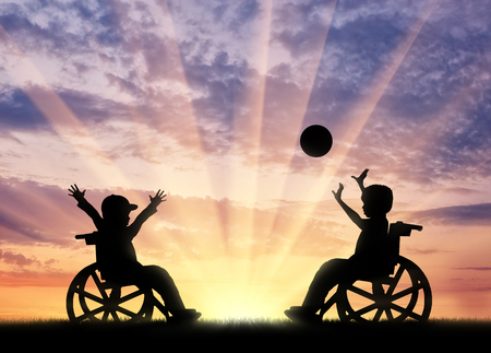 Happy children disabilities play ball sunset. Concept happy children disabilitiesの写真素材