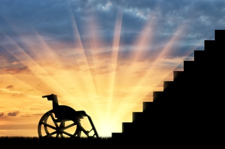 Wheelchair in front of stair sunset. Concept of disabilityの写真素材