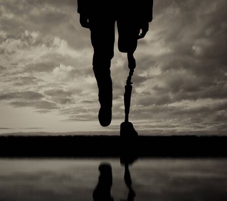 Leg prosthesis and reflection in water black and white. Concept disabledの写真素材