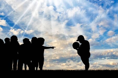 Children refuse to play with fat boy and expel him in day. Concept of childhood obesityの写真素材
