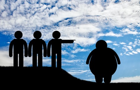 People stand and banish fat man on sky background. Concept obesityの写真素材