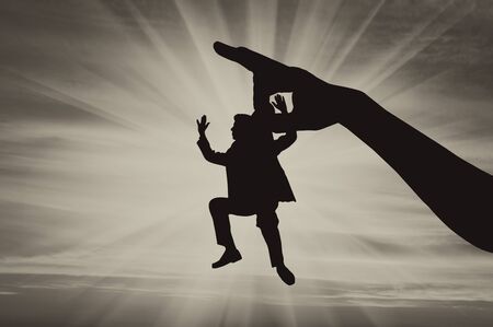 Man was fired and big hand throws him. Concept dismissalの写真素材