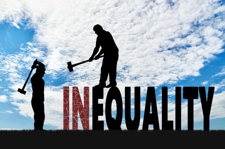 Silhouette of two men with sledgehammers smash word inequality. Social inequality and notion equality of rightsの写真素材