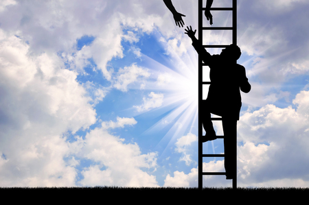 Businessman climbing stairs and a helping hand. Concept of helpingの写真素材