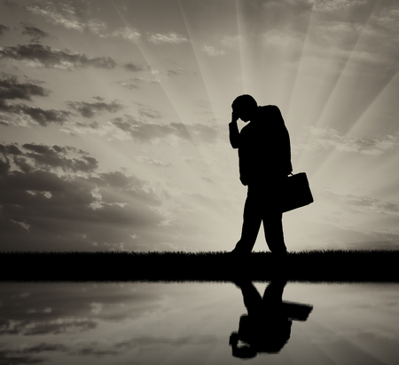 Sad man with a briefcase. Concept of job loss and dismissalの写真素材