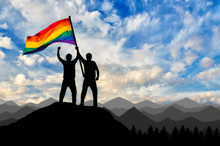 Silhouette of a gay couple with rainbow flag at the top. Concept gay rightsの写真素材