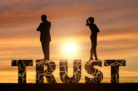 Distrust and betrayal in the family. Wife and husband are on a cracked word of trustの写真素材
