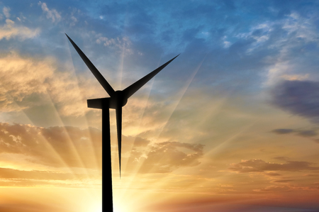 Silhouet a wind generator against a sunset background. Concept of renewable energyの写真素材