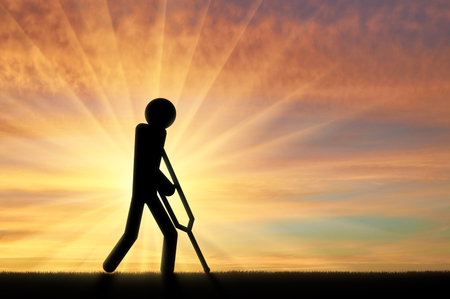 Disabled person with crutches in hands of a person icon. Concept of disabled peopleの写真素材