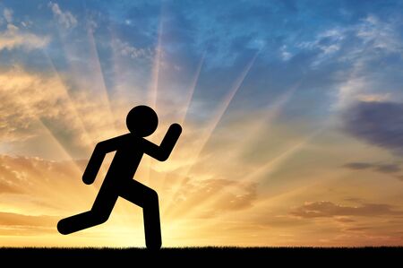Flat icon of a man runs against the sunset. Concept of sportの写真素材