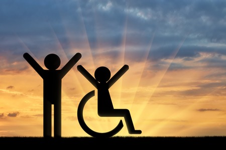 Happy disabled person next to a healthy person . Concept of support for people with disabilitiesの写真素材