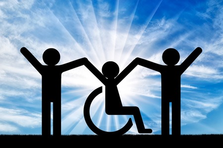 Happy disabled person in a wheelchair together with healthy people. Concept of support and assistanceの写真素材