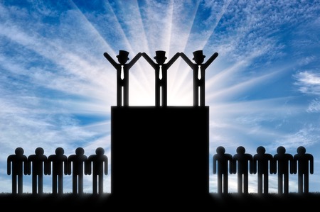 Concept of inequality. Rich people stands on hill and ordinary people at bottomの写真素材