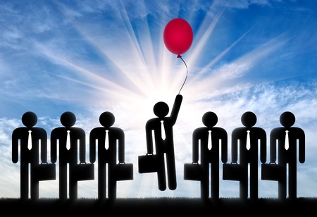 Leader among the crowd concept. Man with balloon in hand to fly up among ordinary peopleの写真素材