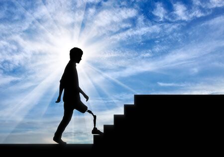 Walking disabled with a prosthetic leg climbs the stairsの写真素材