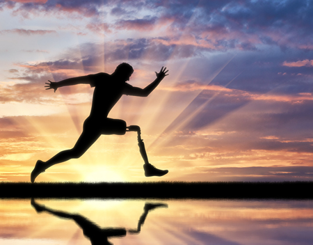 Running a disabled person with a prosthetic leg, confidently running on the ground and its reflection in the river