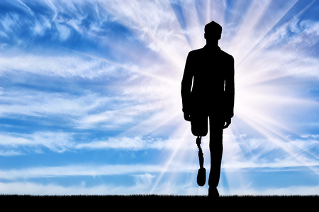 Walking disabled with prosthetic legs against the skyの写真素材