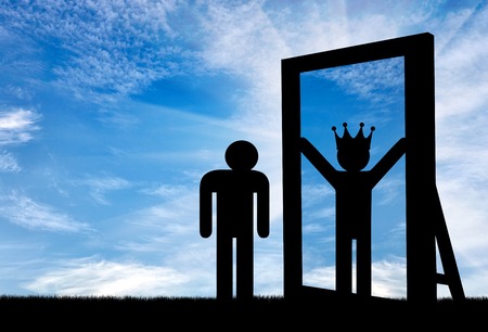 Concept of narcissism and selfishness. Silhouette of an icon of a man standing at a mirror and sees himself in a reflection of the great and with a crown on his headの写真素材