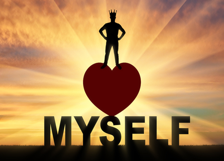 Concept of narcissism and selfishness. Silhouette of a narcissist with a crown on his head against a sunset backgroundの写真素材
