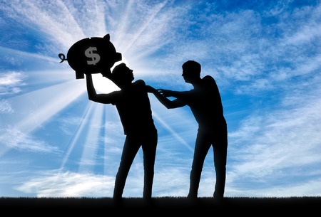 Concept of greed and selfishness. Silhouette of a man trying to take from another man a piggy bank with moneyの写真素材