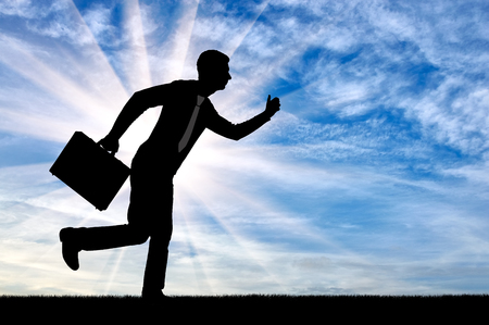 The concept of a hard-working businessman. Silhouette of a busy and hardworking businessmanの写真素材