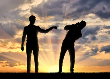 Silhouette of a man showing a finger at another man. The concept of charges in the societyの写真素材