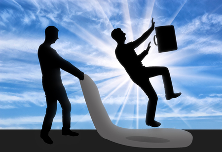 Silhouette of a businessman who does meanness to another businessman. The concept of a rival in businessの写真素材