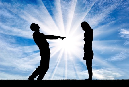 A man laughs at a woman pointing at her with a finger. The concept of feminism and discriminationの写真素材