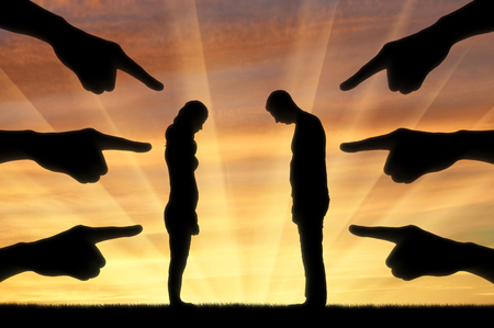 Silhouette, humiliated the man and woman hands pointing a finger at them. The concept of shame and humiliationの写真素材