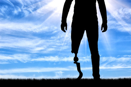A man with a prosthetic leg standing closeup. The concept of prosthetic legsの写真素材