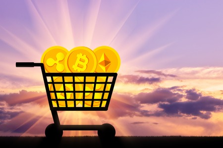 Coins of crypto currency lie in the grocery cart. The concept of buying and selling of crypto currencyの写真素材