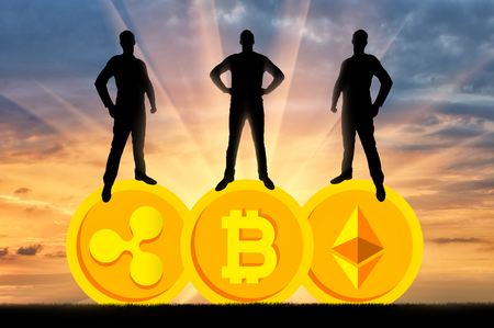 Three businessmen are standing on three coins of the crypto currency. The concept of business in the crypto currencyの写真素材