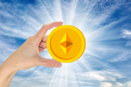 Ethereum in hand against the sky. The concept of crypto currencyの写真素材
