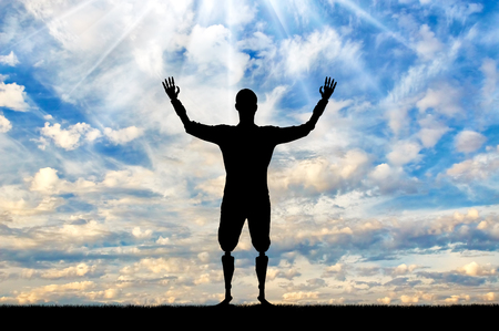 Happy silhouette of a disabled man with prosthetic hands and feet. The concept of people with disabilities with limb prosthesesの写真素材