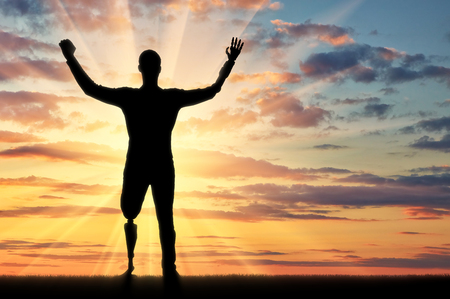 Happy silhouette of a disabled man with prosthetic arms and legs. Concept of people with disabilities with limb prosthesesの写真素材