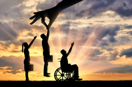 Employer's hand chooses a healthy worker from a crowd of people and not an invalid in a wheelchair. The Concept of Discrimination and Inequality in the Employment of People with Disabilitiesの写真素材