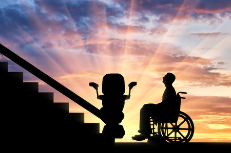 Disabled in wheelchair intends to climb elevator for disabled. Concept disabled lift, elevator, handicapの写真素材